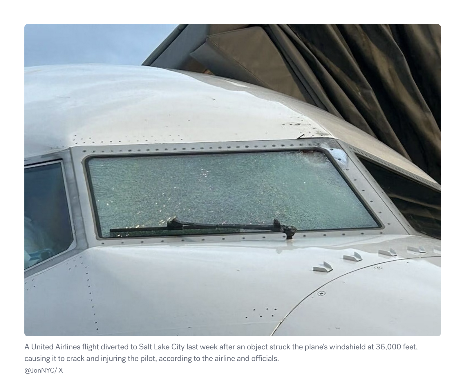 Plane with a cracked window and damage around the edge of the window