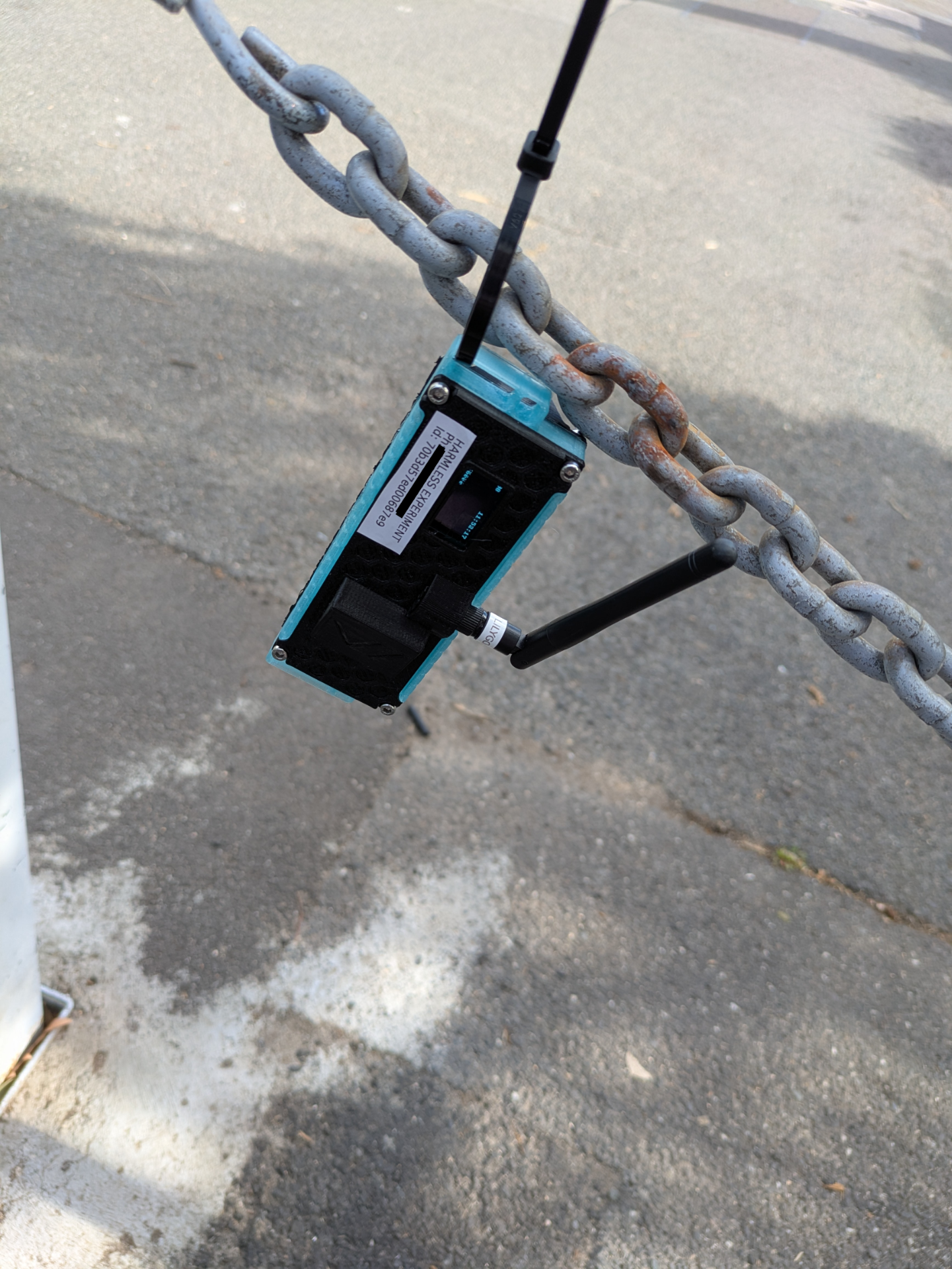 TBeam transmitter cable tied to a chain fence