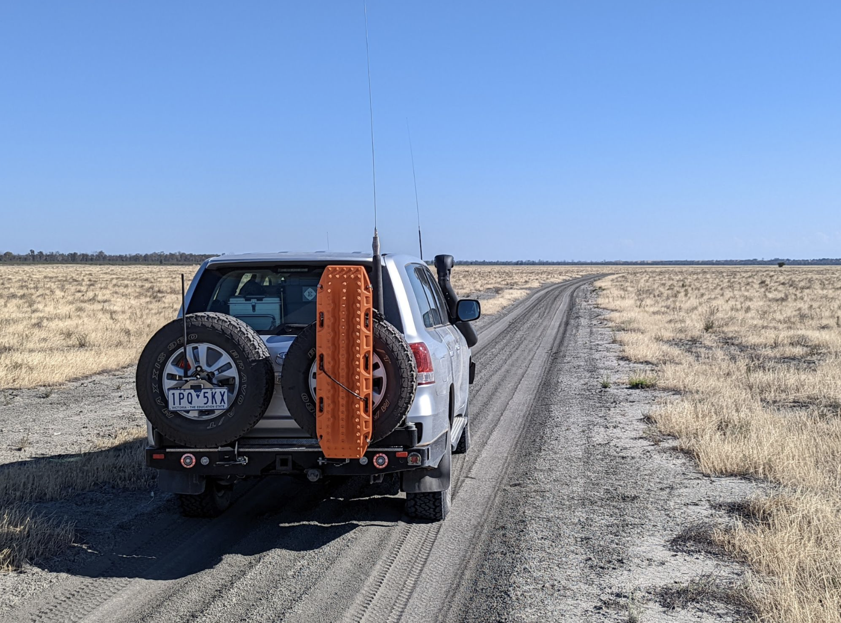 Our 4x4 with large HF antennas mounted driving through a dry lake