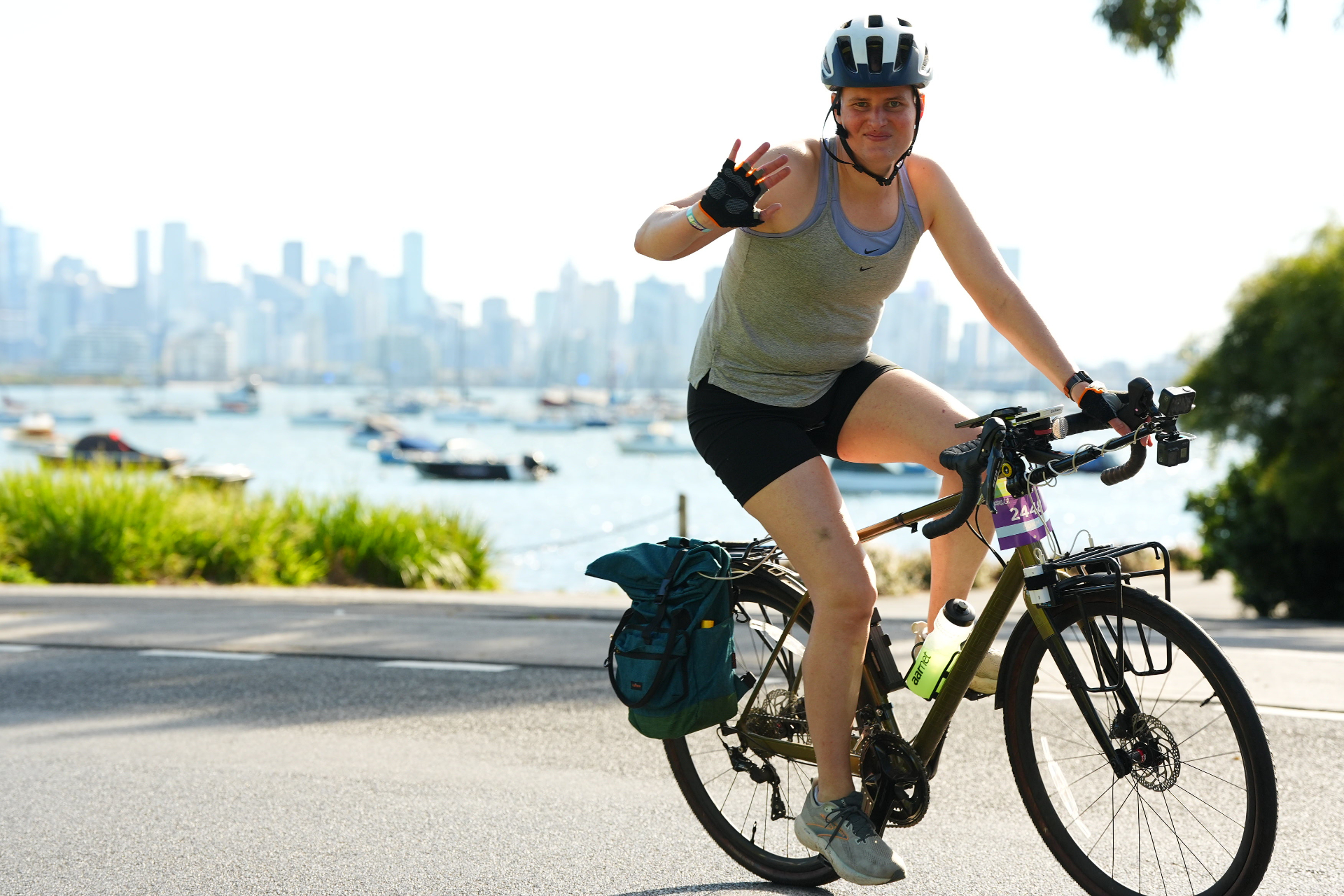Picture of me riding in around the bay with the Melbourne cityscape in the background. I&rsquo;m waving to the camera