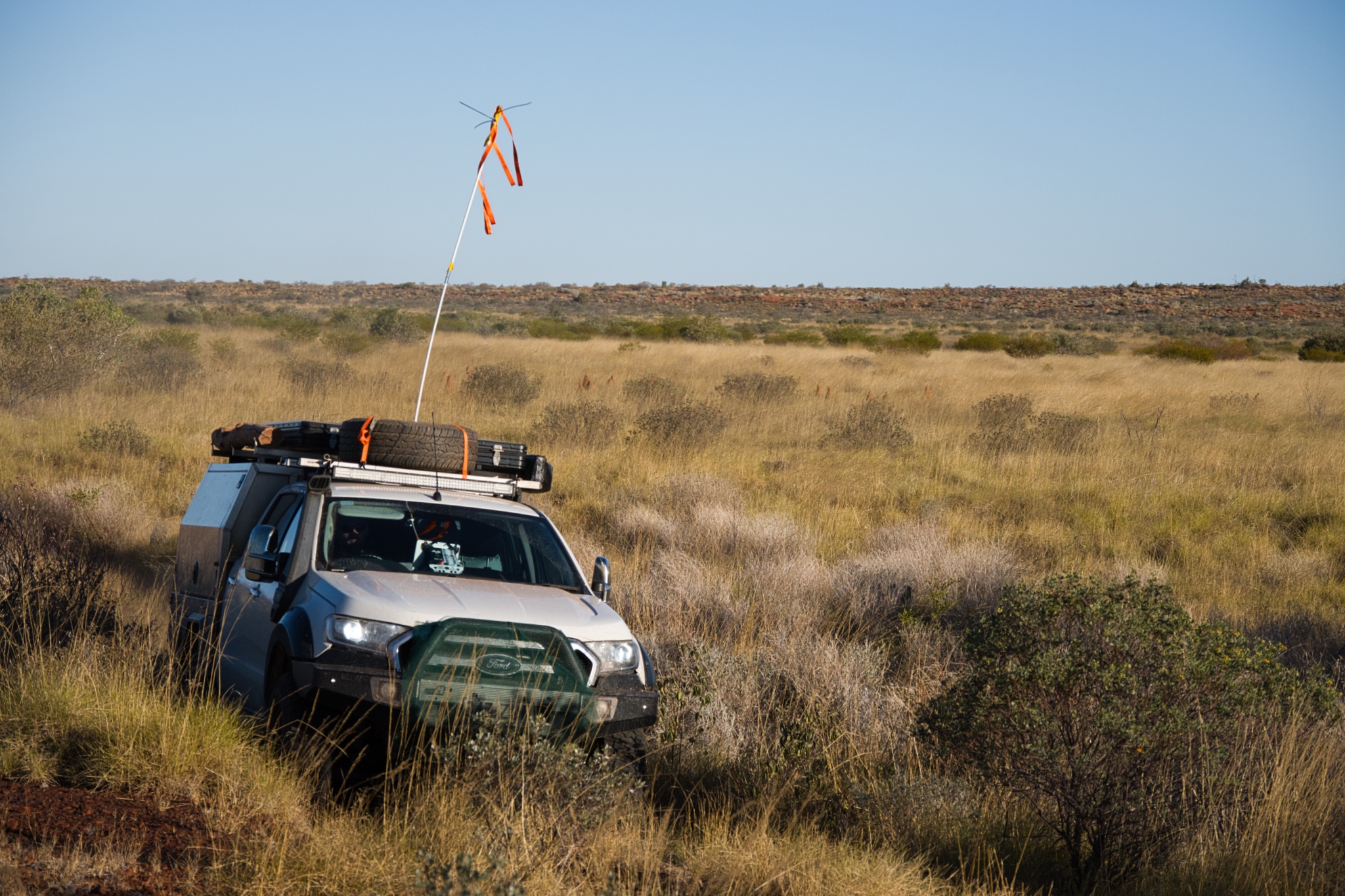 Rusty&rsquo;s vehicle traveling through the golden spinifex