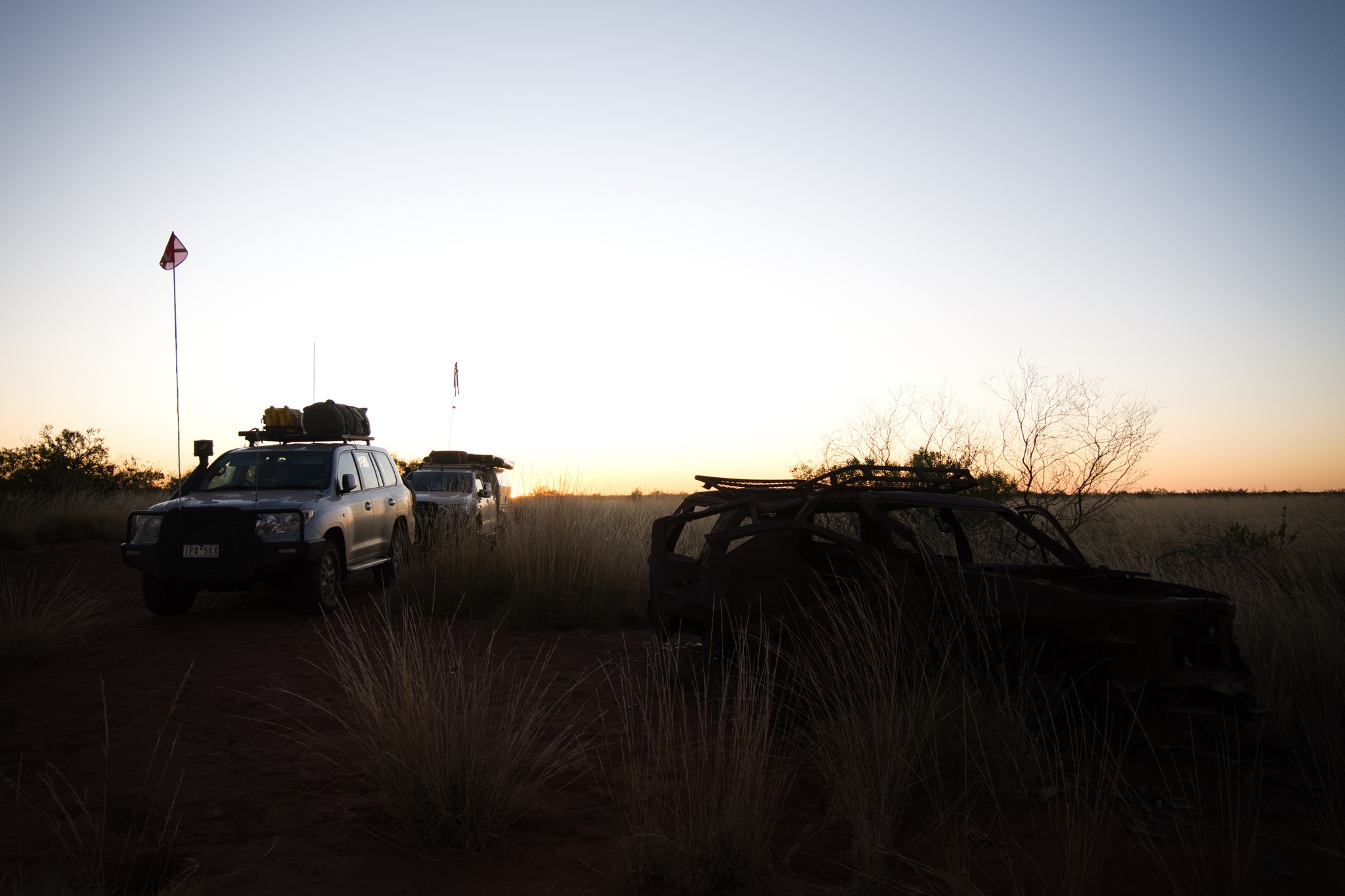 Burnt out vehicle at sunset