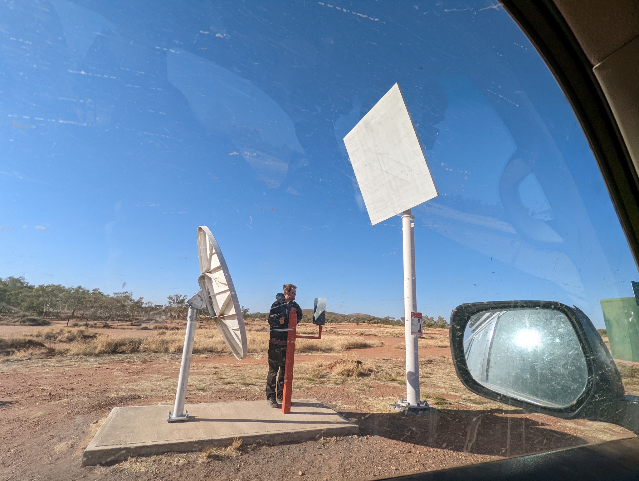 My dorky boy friend trying their best to get internet along the way using a road side passive RF reflector