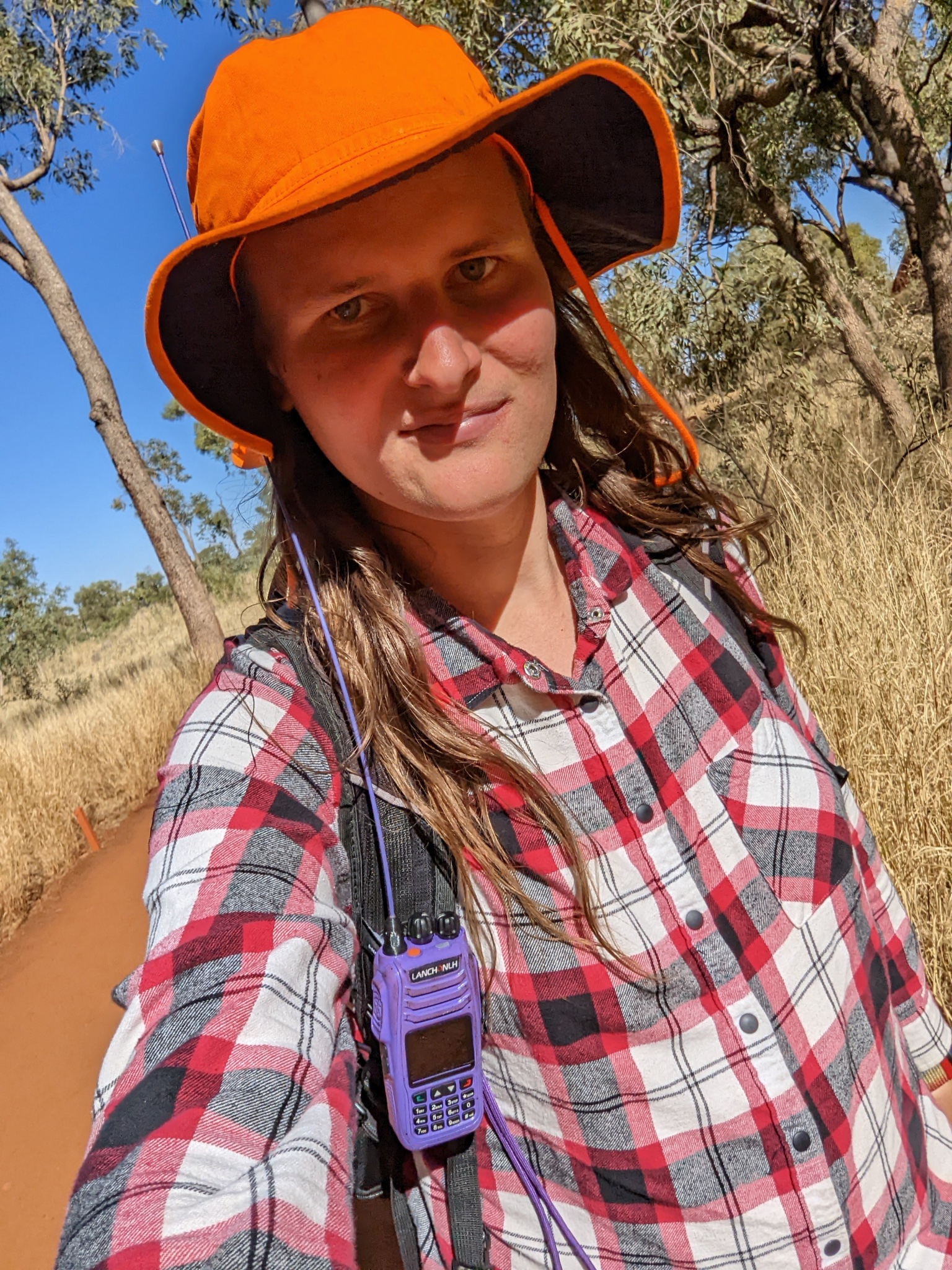 Selfie of me with a radio clipped to backpack