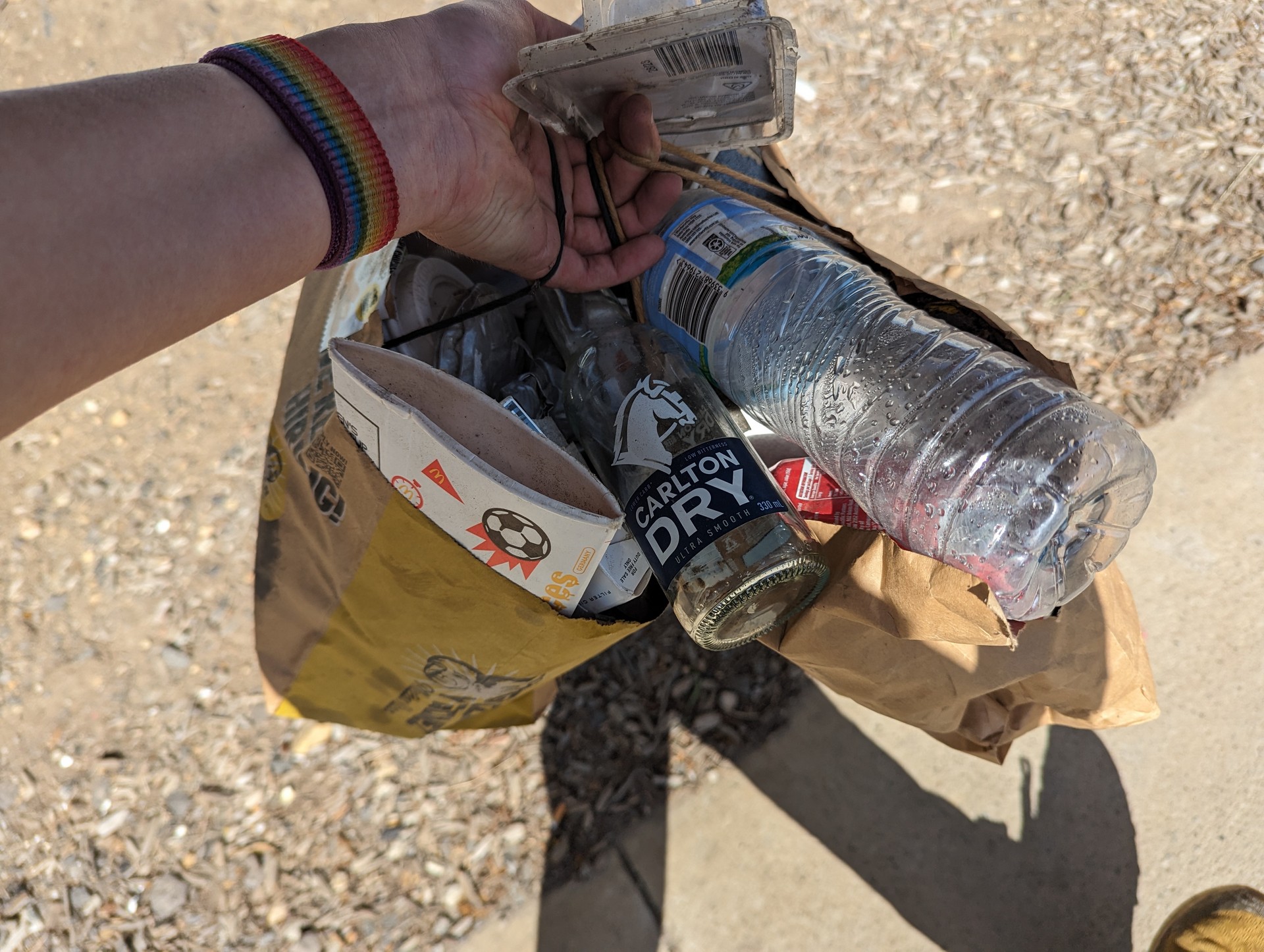 Two bags over full of bottles and containers