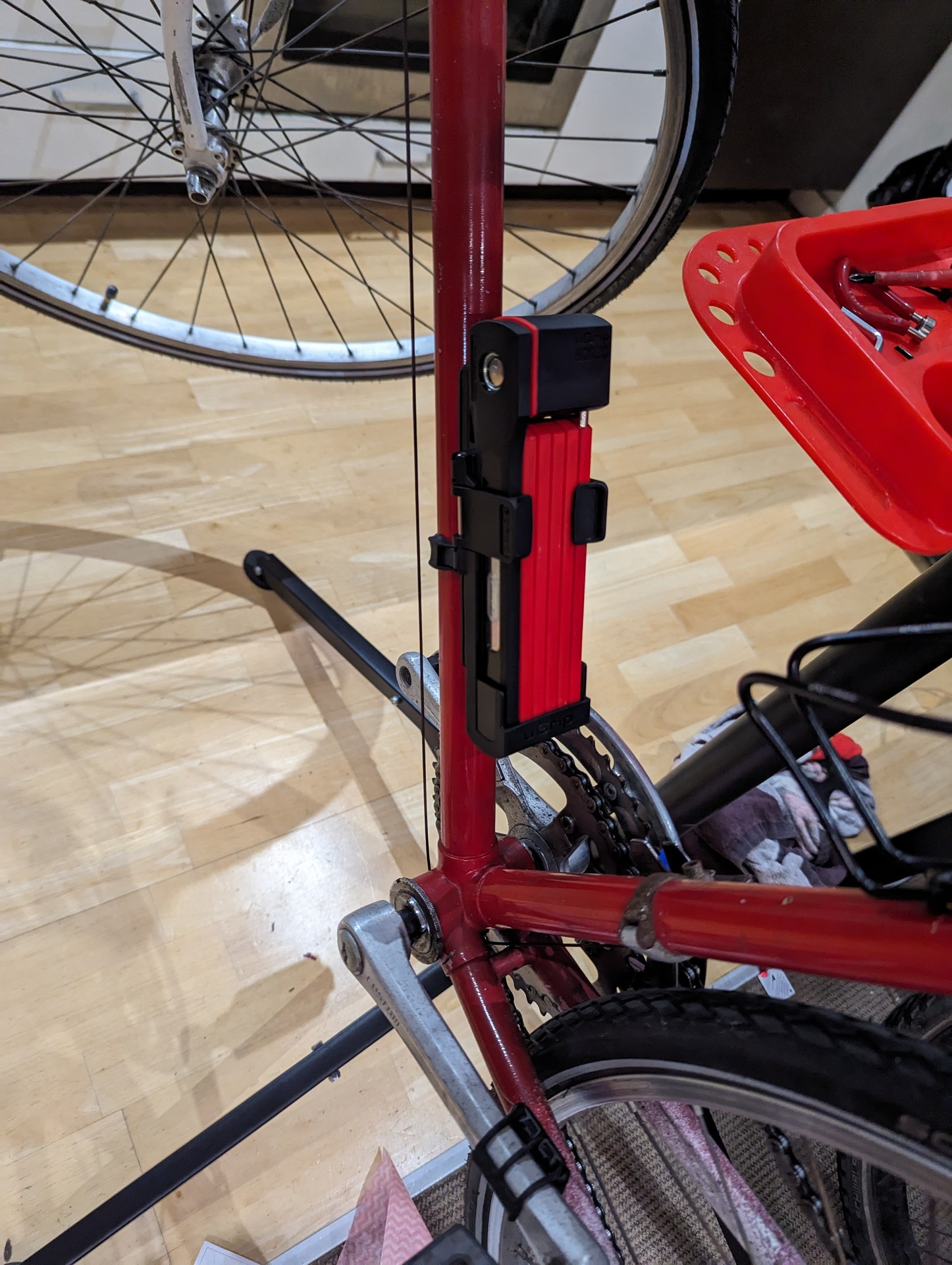 ABUS folding bike lock installed in one of the bottle cage mounts