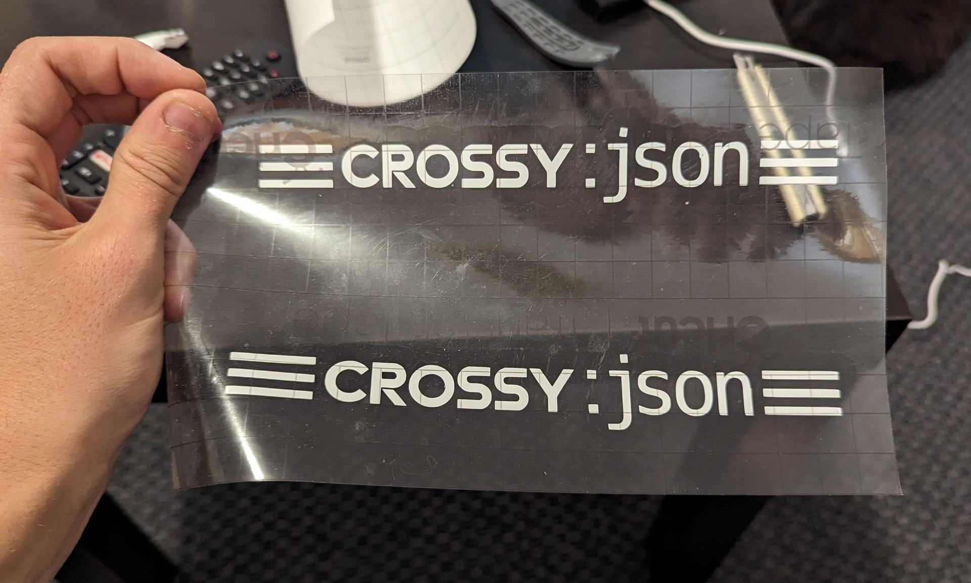 CROSSY JSON decal on transfer paper with thick horiztonal lines to replicate  the feel of the original logo