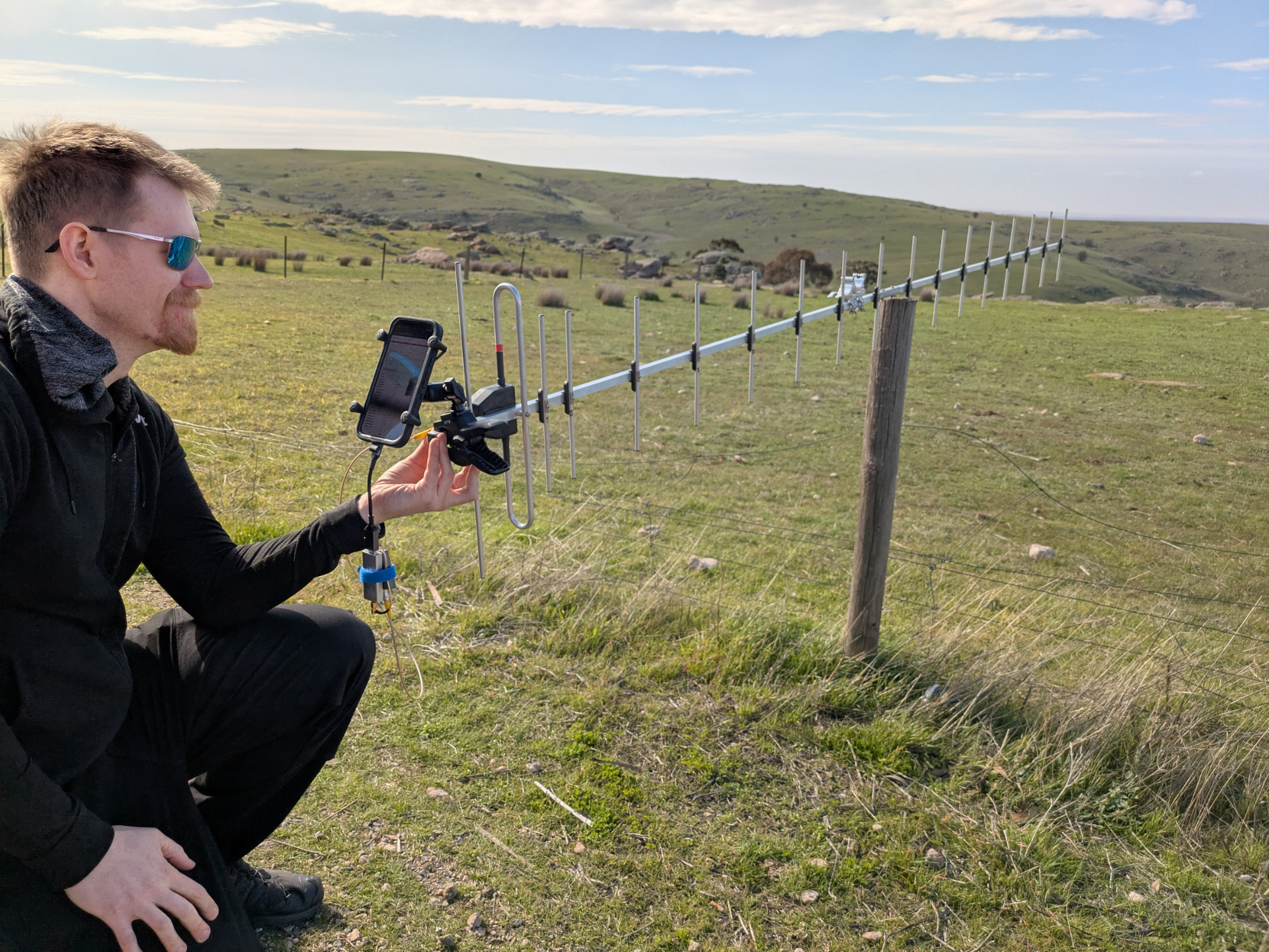 Droppy with their phone attached to a very very long yagi receiving images from the payload