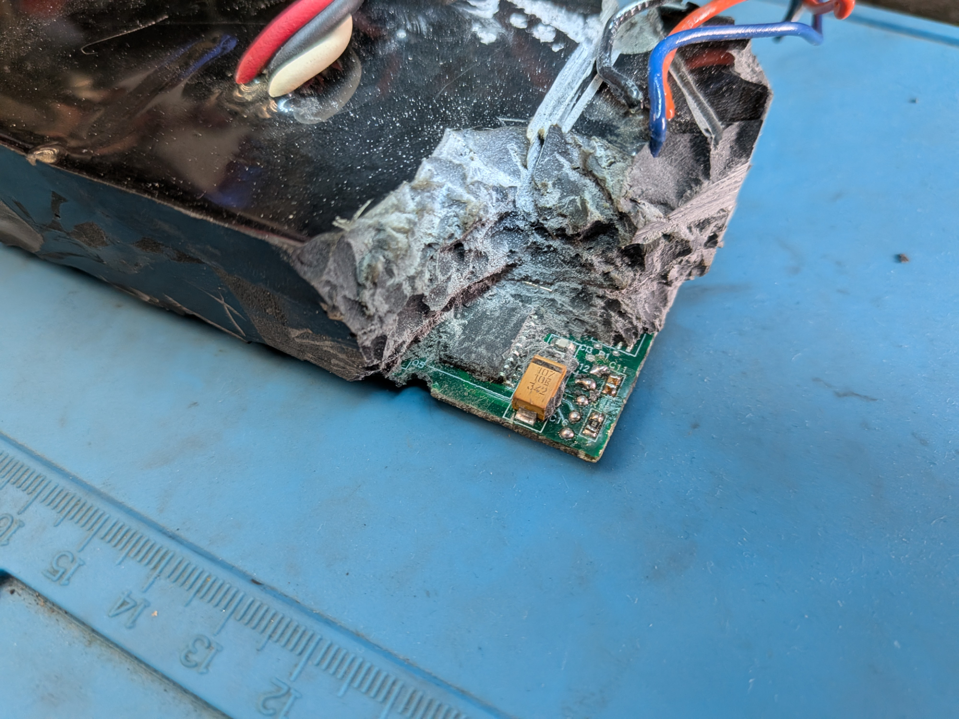 De-potting of the power supply. The potting is very deep and only the PIC chip is revealed