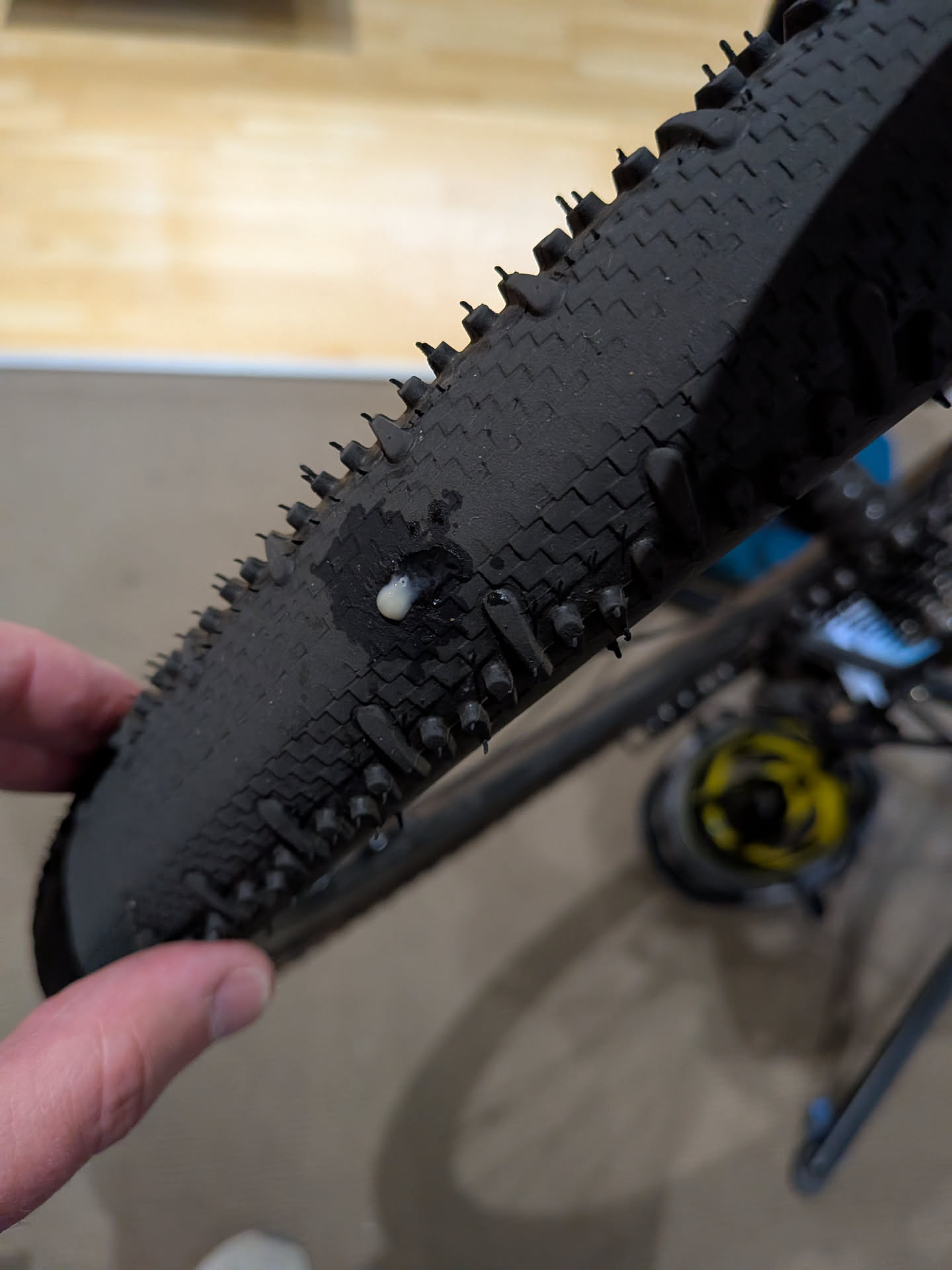 Inspecting tyre and showing leaking sealant