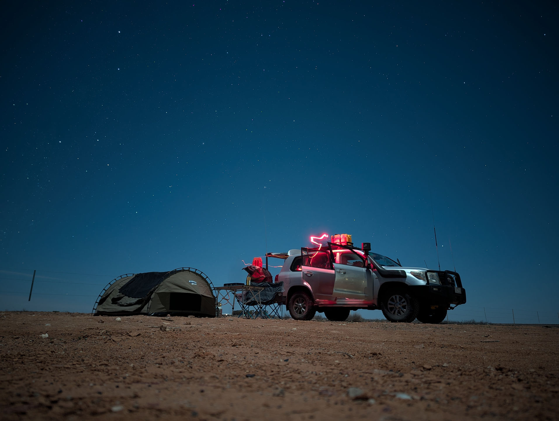 swag setup at william creek in the stars next to the car and camp table